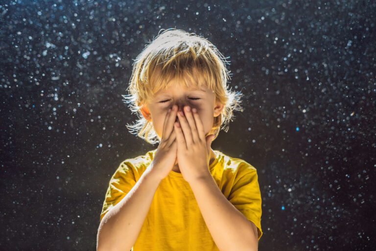 Boy covering nose from allergens