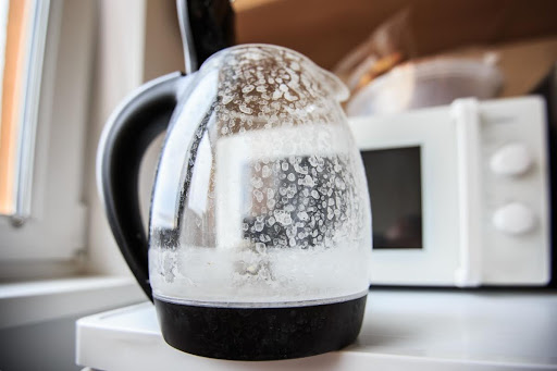 Hard water spots on a kettle in a kitchen.